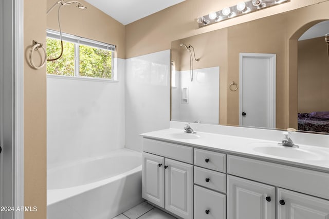 bathroom with tile patterned flooring, shower / tub combination, and vanity