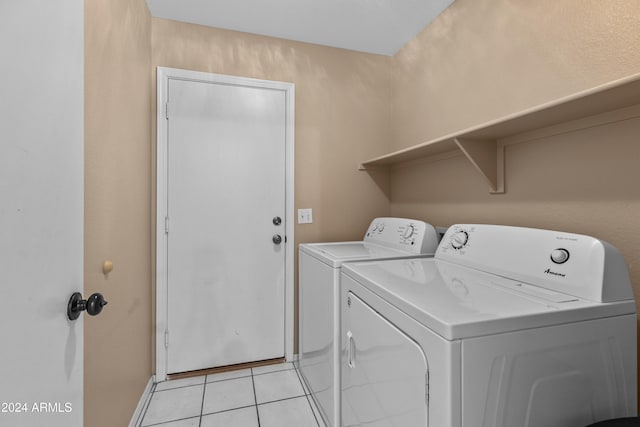 washroom with independent washer and dryer and light tile patterned floors