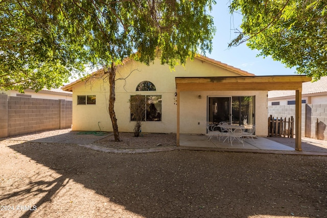 back of property featuring a patio