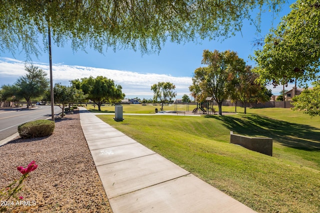 view of property's community featuring a yard and a playground