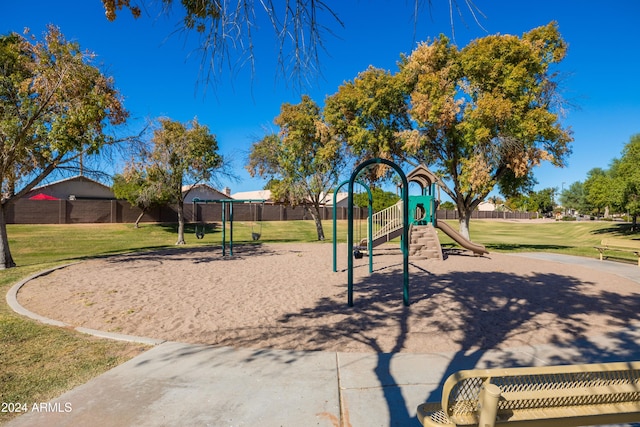 view of jungle gym featuring a lawn