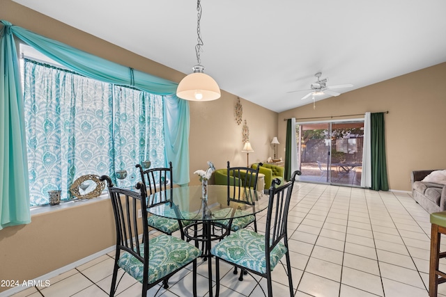 tiled dining area featuring ceiling fan and lofted ceiling