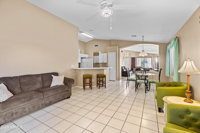 tiled living room with ceiling fan and lofted ceiling