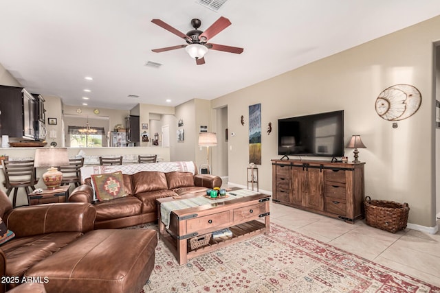 living room with ceiling fan with notable chandelier and light tile patterned flooring