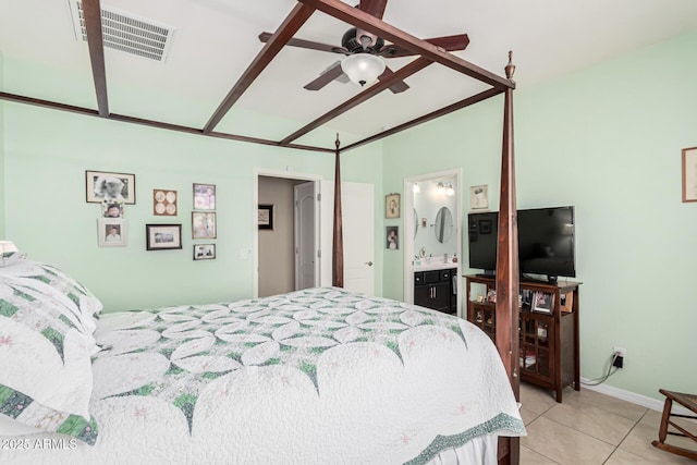 tiled bedroom featuring ceiling fan and ensuite bath