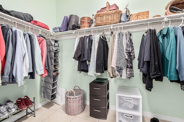 spacious closet featuring light tile patterned floors