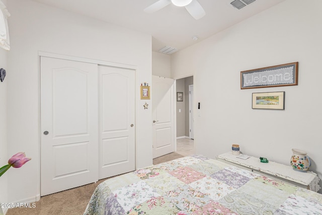 carpeted bedroom featuring a closet and ceiling fan