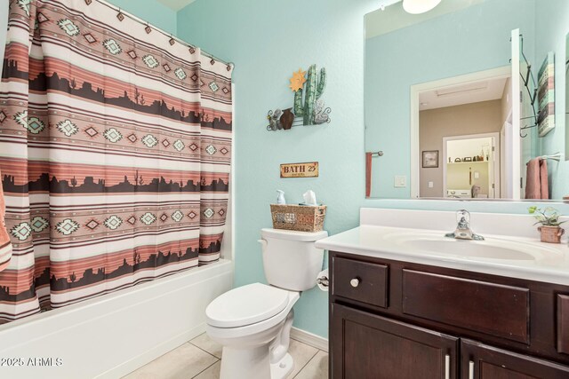 full bathroom featuring shower / bath combination with curtain, vanity, tile patterned floors, and toilet