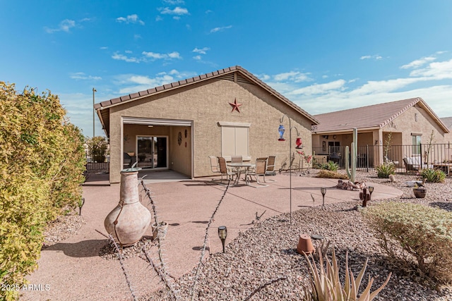 rear view of property featuring a patio area