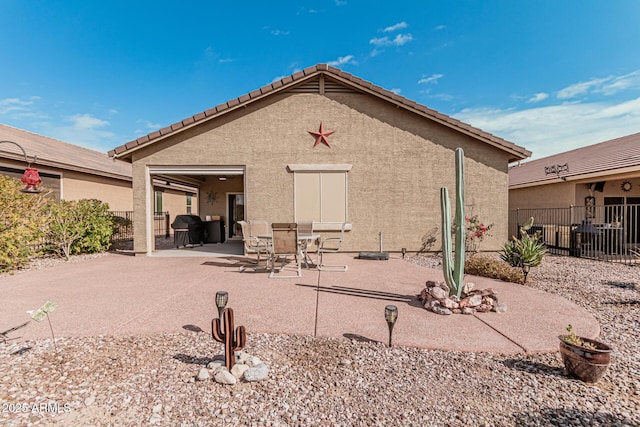 back of property with a patio area