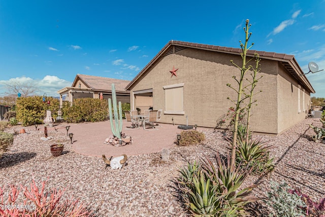 rear view of property featuring a patio