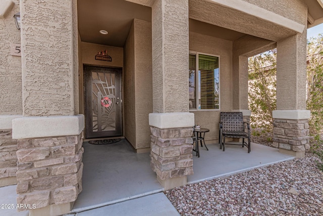 entrance to property featuring covered porch