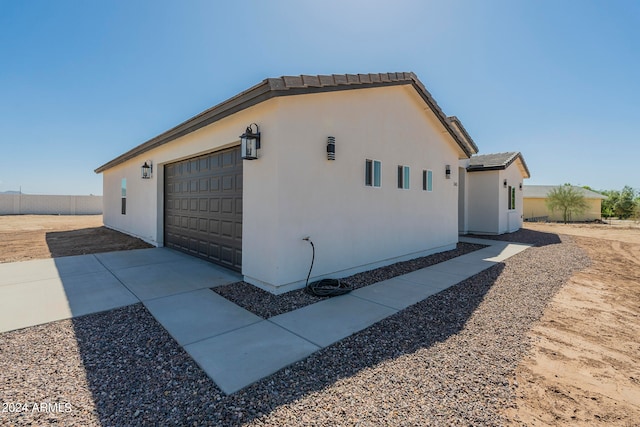 view of side of property featuring a garage