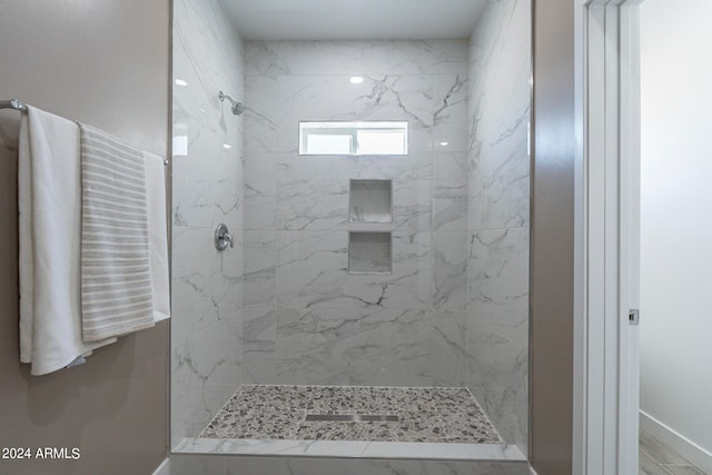 bathroom with tiled shower