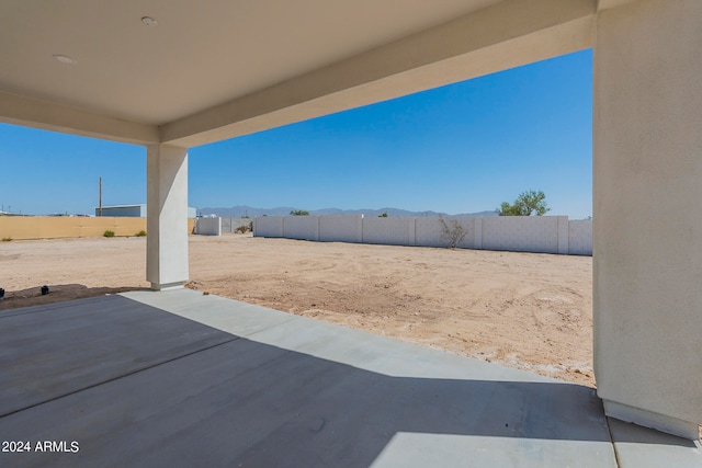 view of yard featuring a mountain view and a patio area