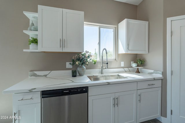 kitchen featuring dishwasher, white cabinets, and sink