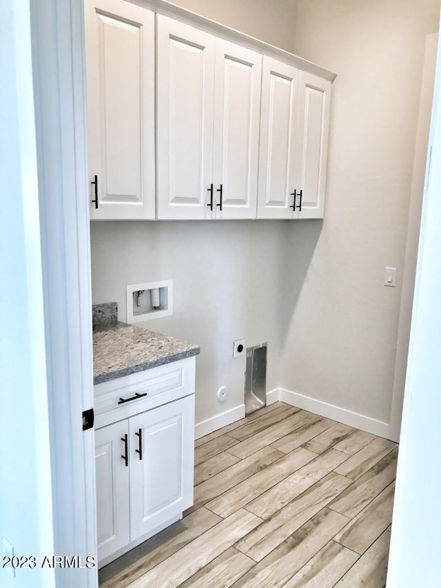 3785 W Silverdale Rd, Queen Creek, AZ 85144 - clothes washing area with electric dryer hookup, light hardwood / wood-style floors, cabinets, washer hookup, and gas dryer hookup