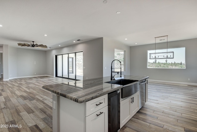 3785 W Silverdale Rd, Queen Creek, AZ 85144 - kitchen featuring light hardwood / wood-style flooring, decorative light fixtures, a kitchen island with sink, and white cabinetry