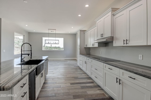 3785 W Silverdale Rd, Queen Creek, AZ 85144 - kitchen with pendant lighting, dark stone countertops, light hardwood / wood-style floors, black appliances, and white cabinetry