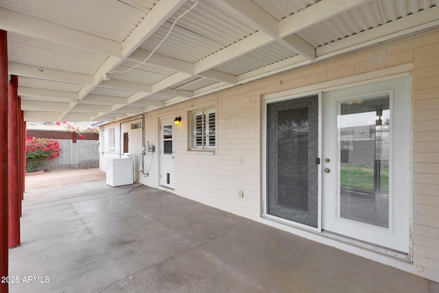 view of patio featuring washer / clothes dryer and fence