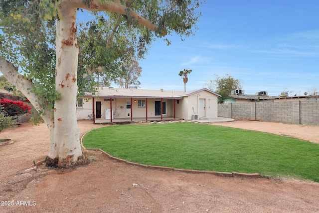 exterior space with a patio, a front lawn, and fence