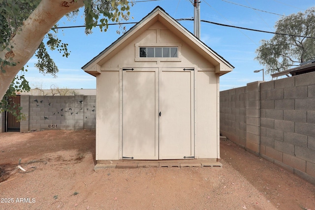 view of shed with a fenced backyard