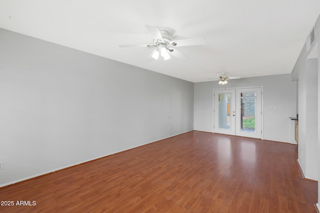 spare room featuring a ceiling fan, french doors, and wood finished floors