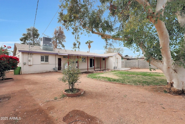 rear view of property featuring central AC, fence, and a patio