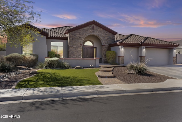 view of front of property featuring an attached garage, concrete driveway, stone siding, stucco siding, and a front lawn