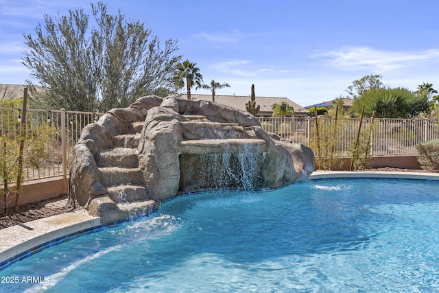 view of swimming pool featuring a fenced in pool and fence