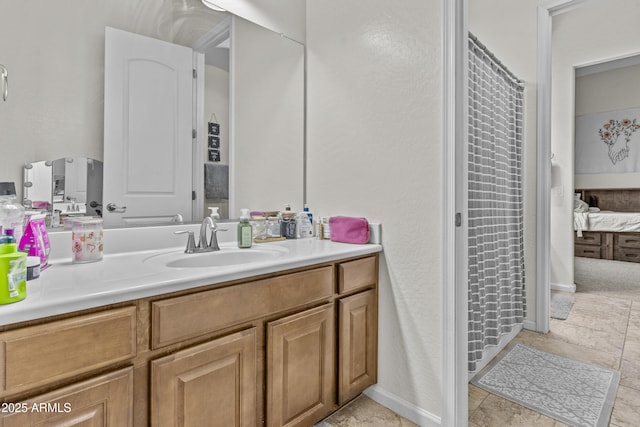 ensuite bathroom with curtained shower, baseboards, ensuite bathroom, and vanity