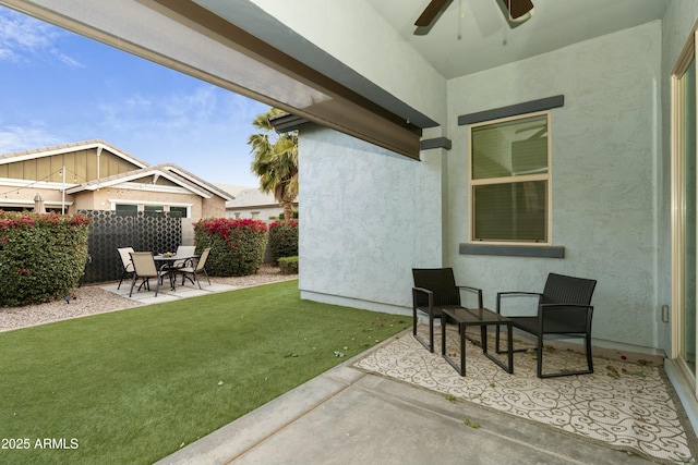 exterior space with ceiling fan and a patio area