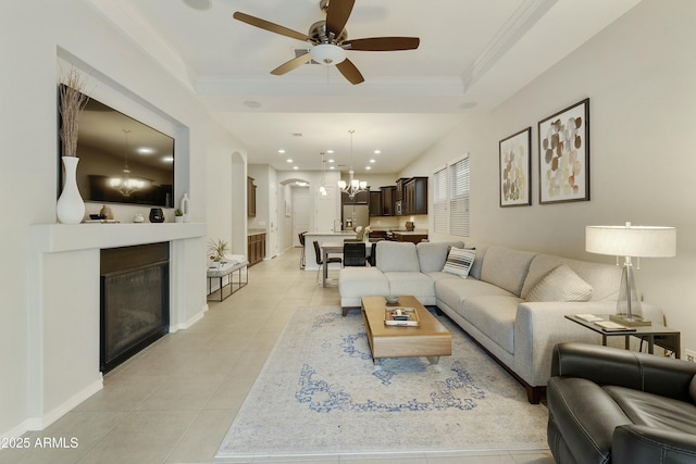 living room with ceiling fan, light tile patterned floors, and ornamental molding