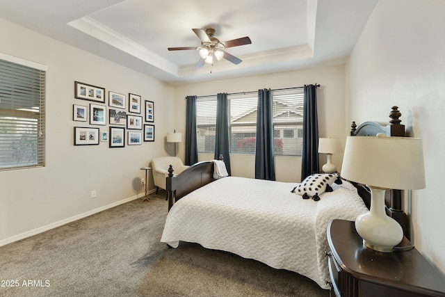 bedroom with carpet floors, a raised ceiling, and ceiling fan