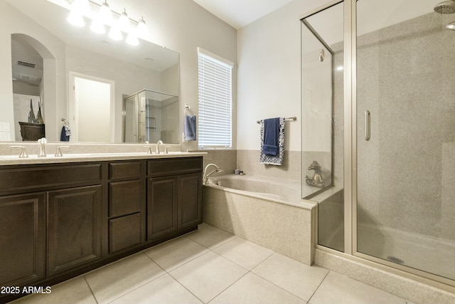 bathroom featuring tile patterned floors, vanity, and plus walk in shower