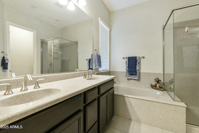 bathroom featuring tile patterned flooring, vanity, a healthy amount of sunlight, and shower with separate bathtub