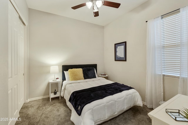 carpeted bedroom featuring ceiling fan and a closet