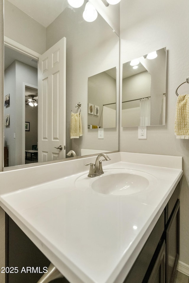 bathroom featuring ceiling fan and vanity