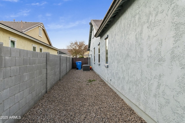 view of side of property featuring central air condition unit