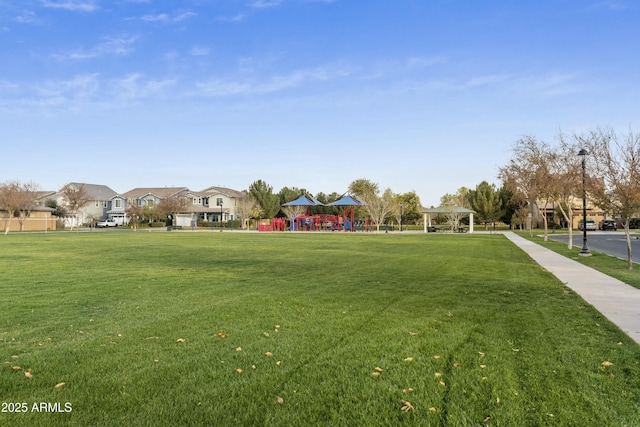 view of property's community featuring a yard and a playground