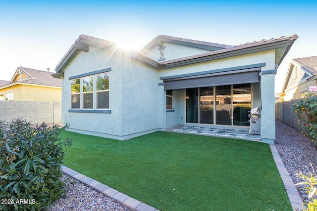 rear view of property with a yard