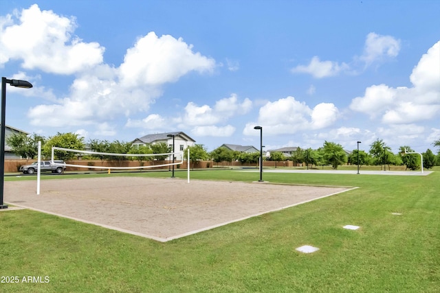 view of property's community with volleyball court and a yard