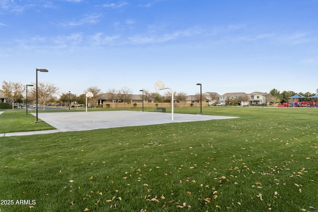 view of basketball court featuring a yard