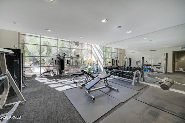 exercise room with recessed lighting, floor to ceiling windows, and visible vents