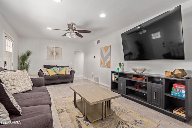 living room featuring ceiling fan and light hardwood / wood-style flooring