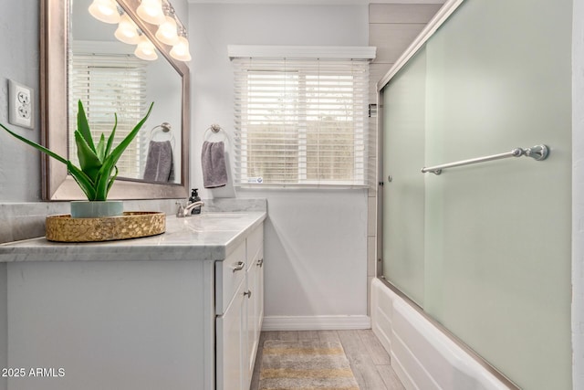 bathroom featuring vanity and bath / shower combo with glass door