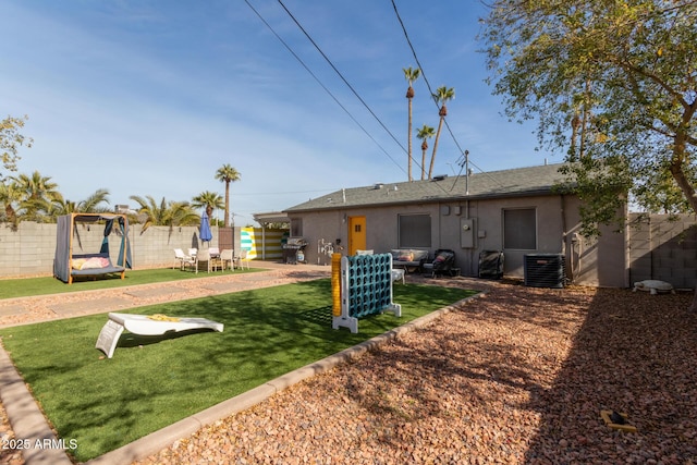 back of property featuring a patio area, central AC unit, and a lawn