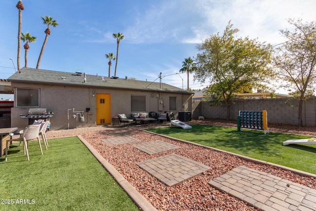 back of house featuring cooling unit, a yard, and a patio area