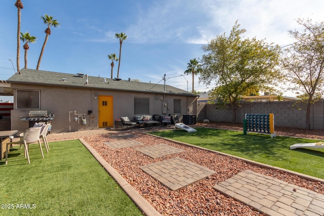 rear view of property with a patio, central AC, and a lawn