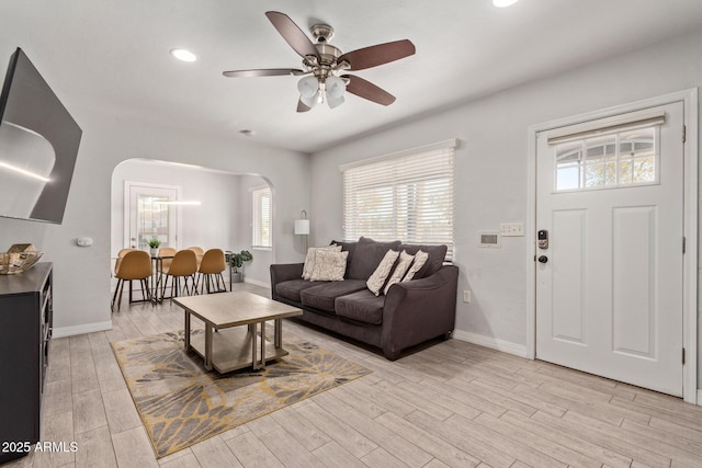 living room featuring ceiling fan and light wood-type flooring